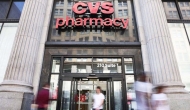 CVS Pharmacy sign on large entrance with stone pillars