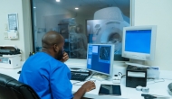 Healthcare worker controlling an MRI machine